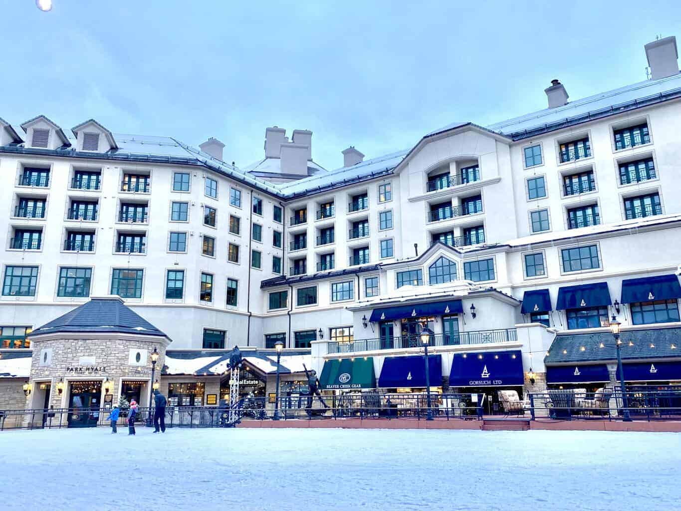 Park Hyatt Beaver Creek hotel beside the village ice rink in winter