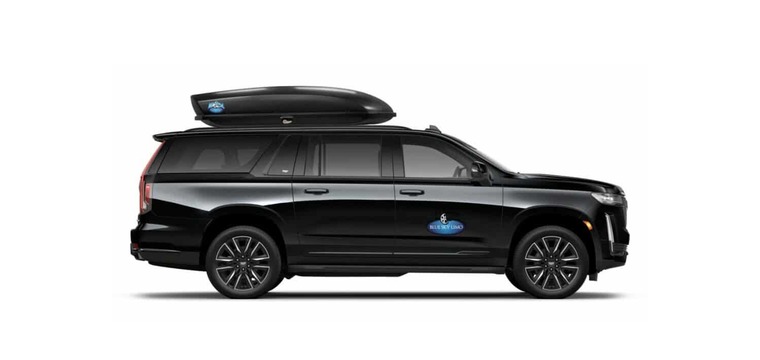 Large private SUV for Aspen airport shuttle service with rooftop cargo box