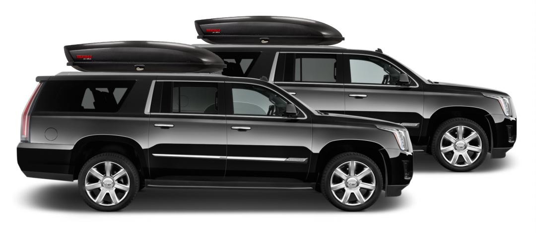 Two private XL SUVs with rooftop cargo boxes for larger Aspen airport shuttle groups