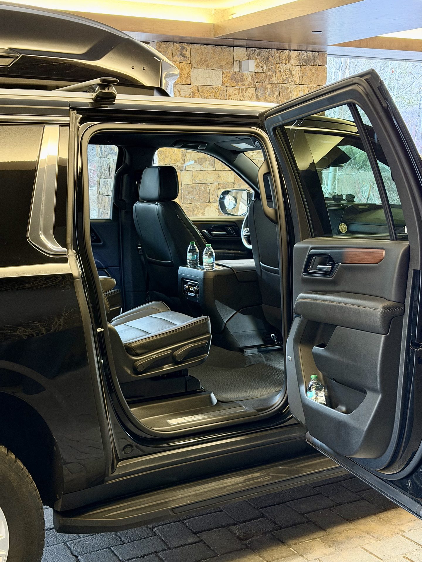 Open rear passenger door and leather seating in a Blue Sky Limo GMC Yukon Denali
