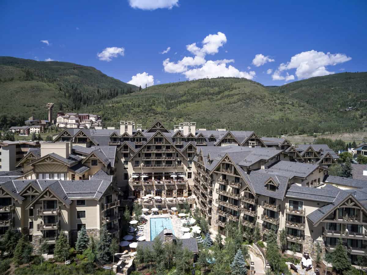 Four Seasons Resort and Residences Vail buildings and courtyard pool beneath Vail Mountain